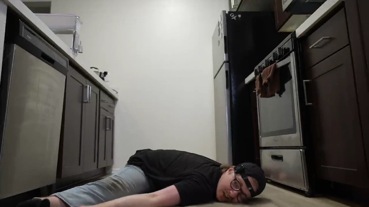 Deep pancake stretch with David lowering his torso between wide legs